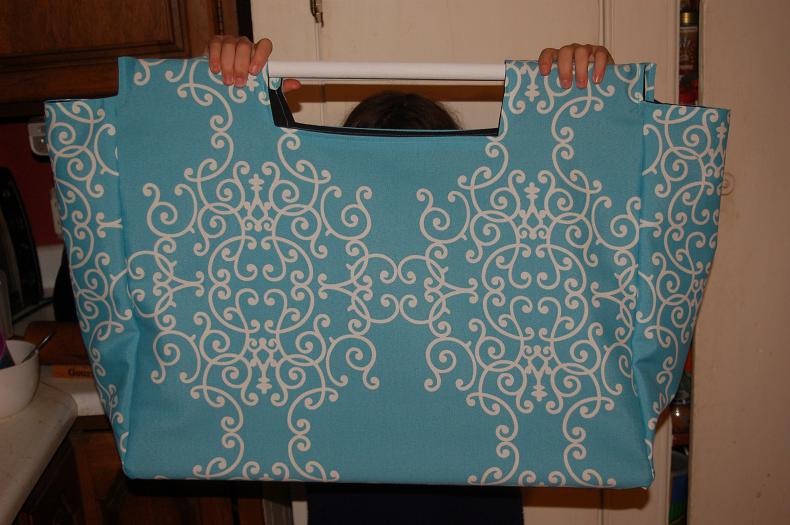 large tote or bag with two long sticks for handles Page 2